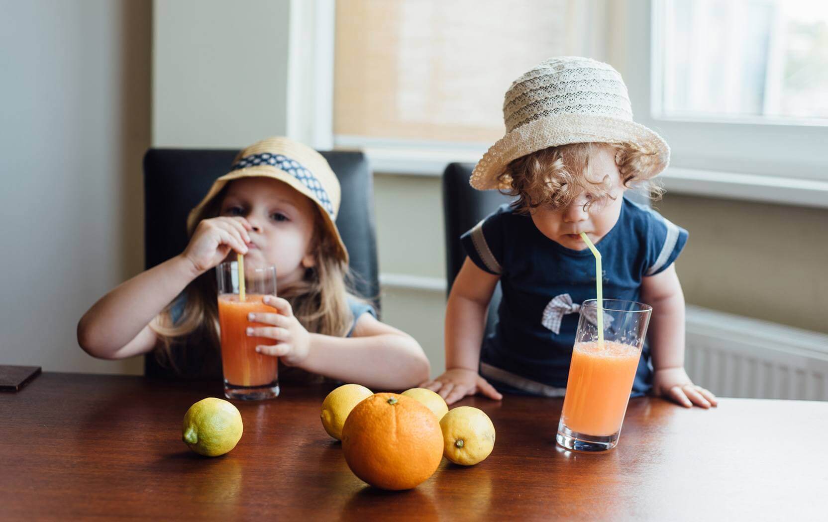Young children drinking healthy Hurom juice